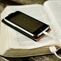 Bible and iPhone. Image shared under a Creative Commons By Attribution license by  pickpix