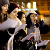Carollers. Photo by Charlotte Tai shared under a Creative Commons, By Attribution license.