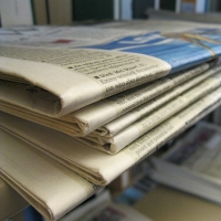 A stack of newspapers. Photograph by the University of Illinois Libraries, shared under a Creative Commons By Atribution 2.0 license. 