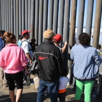 Family seaking asylum at the US Mexico boarder near Tijuana-23rd. November 2018. Image shared under a Creative Commons By Attribution licensed by Daniel Arauz via flickr.