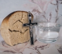 A crucifix, bread and water. Image by Luana da Luz licensed under Creative Commons by Attribution, via  WallpaperFlare.com